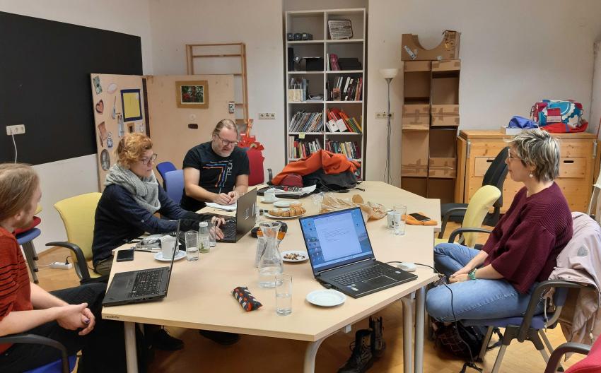 image of people sitting around conference table