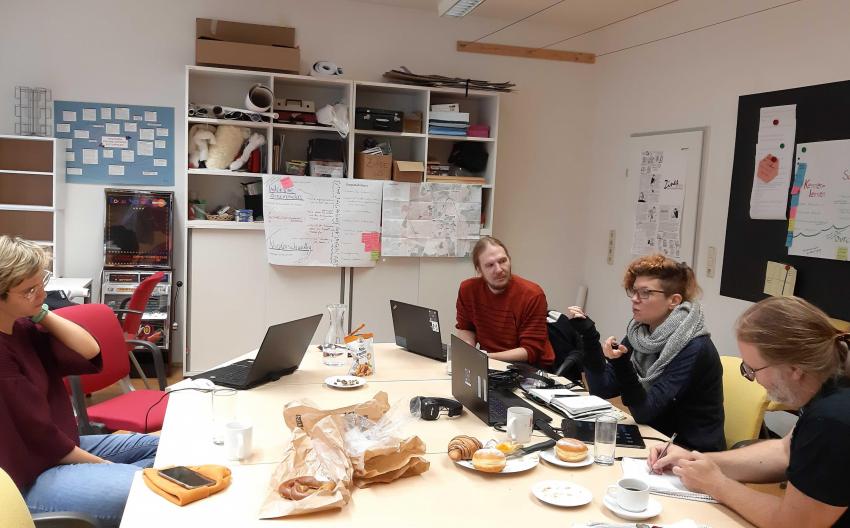 image of people sitting around conference table