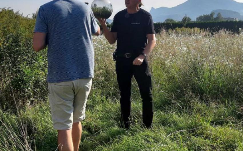 two people in nature holding a silver ball